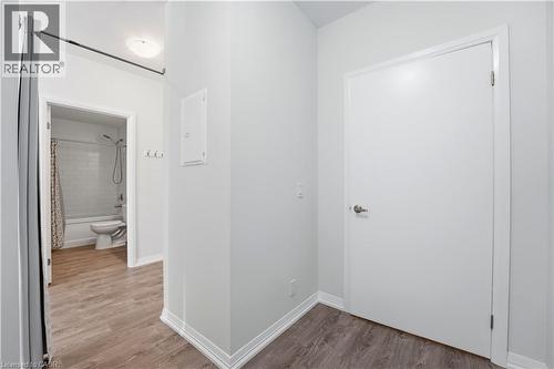 This property features wood-style flooring and light-colored walls throughout - 104 Garment Street Unit# 1206, Kitchener, ON - Indoor Photo Showing Other Room