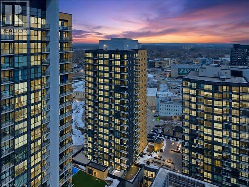 Aerial view of the property and surrounding buildings, featuring modern architecture with extensive window facades - 104 Garment Street Unit# 1206, Kitchener, ON - Outdoor