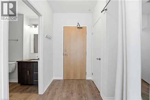 Entryway featuring light wood-style flooring and a light-toned wooden door - 104 Garment Street Unit# 1206, Kitchener, ON - Indoor Photo Showing Other Room
