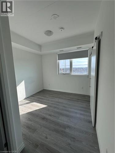 Room featuring a window with a roller blind, and light-toned flooring - 108 Garment Street S Unit# 708, Kitchener, ON - Indoor Photo Showing Other Room