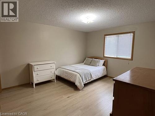 Neutral wall tones with wood-finish flooring - 70 Bechtel Drive, Kitchener, ON - Indoor Photo Showing Bedroom