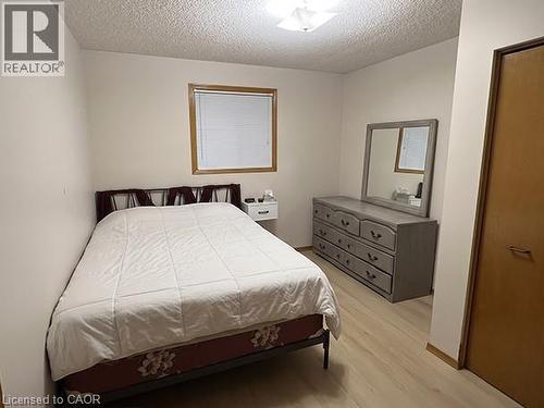 Bedroom featuring light-colored wood-finish flooring, white walls, and a window with wood trim - 70 Bechtel Drive, Kitchener, ON - Indoor Photo Showing Bedroom