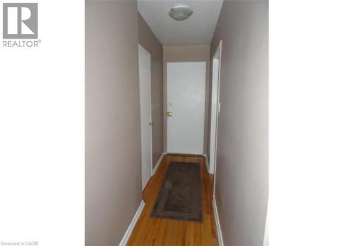 Entryway featuring hardwood floors, light-colored walls, and a ceiling-mounted light fixture - 981 Mohawk Road E, Hamilton, ON - Indoor Photo Showing Other Room