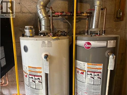 The property features two water heaters, one white and one gray, with visible piping and ductwork - 981 Mohawk Road E, Hamilton, ON - Indoor Photo Showing Basement