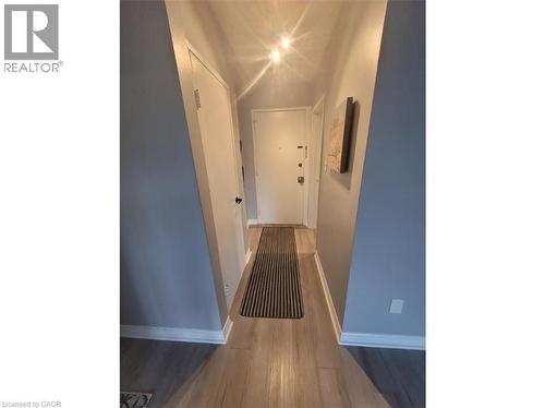 Inviting entryway featuring light-colored flooring, light blue walls, and bright overhead lighting - 981 Mohawk Road E, Hamilton, ON - Indoor Photo Showing Other Room