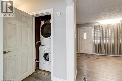 Entryway featuring light-colored flooring and a white front door with decorative glass inserts - 687 Britannia Avenue, Hamilton, ON - Indoor Photo Showing Laundry Room