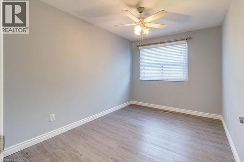 This room features light grey walls, light wood-look flooring, and a ceiling fan with integrated lighting - 687 Britannia Avenue, Hamilton, ON - Indoor Photo Showing Other Room