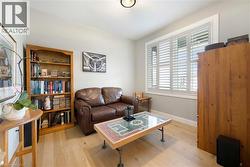 This room features light-colored wood flooring and light gray walls - 