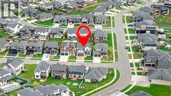 Aerial view of the property and its surrounding neighborhood, showcasing well-maintained streets and green spaces - 