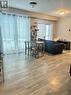 The property features light-toned wood-look flooring and light-colored walls - 275 Larch Street Unit# 108, Waterloo, ON  - Indoor Photo Showing Other Room 
