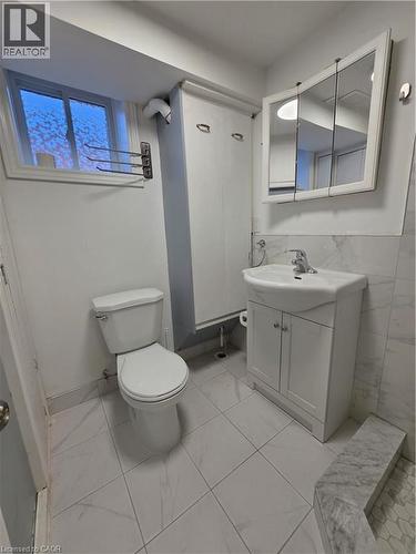 Bathroom featuring a vanity with a white sink, a wall-mounted mirrored medicine cabinet, and tiled floors - 62 Richwill Road Unit# Lower, Hamilton, ON - Indoor Photo Showing Bathroom