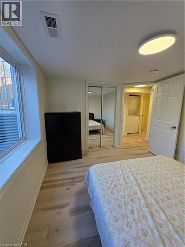 Light-filled room featuring light-toned flooring, a window providing natural light, and a ceiling light fixture - 62 Richwill Road Unit# Lower, Hamilton, ON - Indoor Photo Showing Bedroom