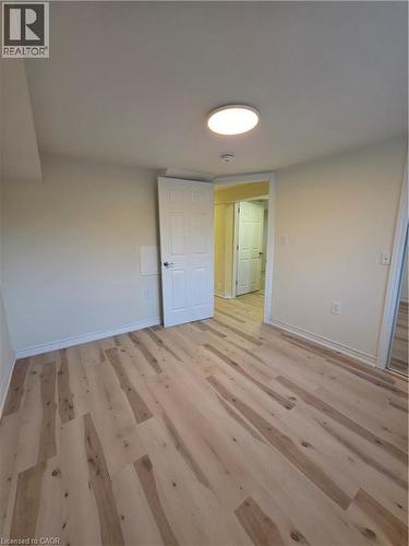 This room features light-colored walls, light wood flooring, and a ceiling light fixture - 62 Richwill Road Unit# Lower, Hamilton, ON - Indoor Photo Showing Other Room