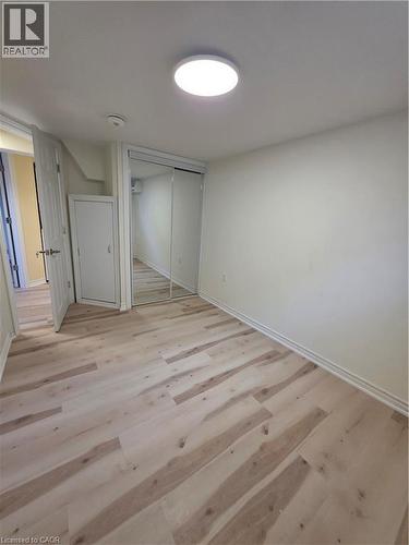 This room features light-toned flooring, white walls, and a ceiling-mounted light fixture - 62 Richwill Road Unit# Lower, Hamilton, ON - Indoor Photo Showing Other Room
