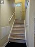 Staircase with light wood treads and a white handrail, leading to an entry door with a decorative glass insert - 62 Richwill Road Unit# Lower, Hamilton, ON  - Indoor Photo Showing Other Room 