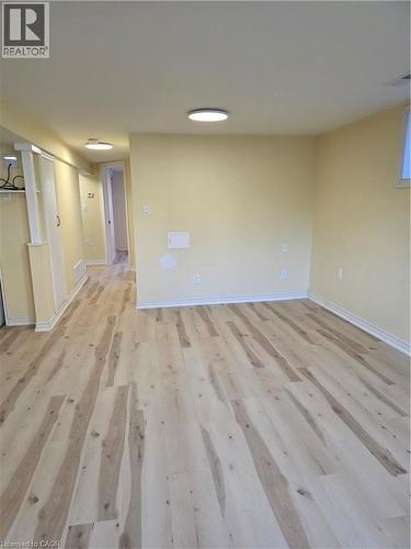 This room features light-colored walls and light wood flooring, illuminated by overhead lighting fixtures - 62 Richwill Road Unit# Lower, Hamilton, ON - Indoor Photo Showing Other Room