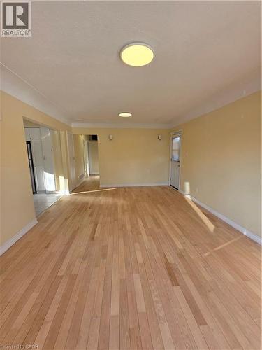 This room features light-toned hardwood flooring, light-colored walls, and a white ceiling with recessed lighting fixtures - 62 Richwill Road Unit# Upper, Hamilton, ON - Indoor Photo Showing Other Room