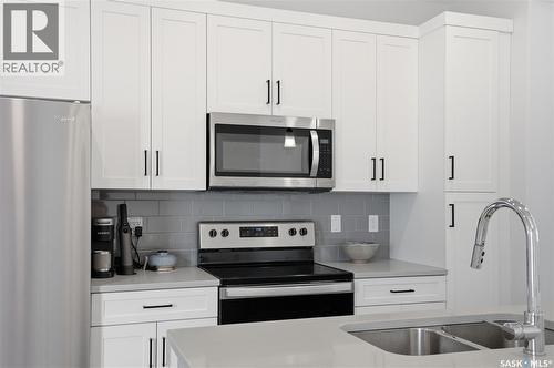 1047 Brighton Gate, Saskatoon, SK - Indoor Photo Showing Kitchen With Stainless Steel Kitchen With Double Sink With Upgraded Kitchen