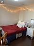 This room features dark hardwood flooring and light-colored walls - 65 Cardill Crescent Unit# B, Waterloo, ON  - Indoor Photo Showing Bedroom 