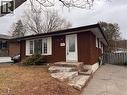 The property features a brick exterior, a front entry door with a decorative glass insert, and a stone pathway leading to the entrance - 23 Arrowhead Crescent Unit# Upper, Kitchener, ON  - Outdoor With Exterior 