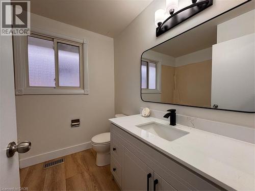 Bathroom featuring a modern vanity with a white countertop, a rectangular sink, and a black faucet - 23 Arrowhead Crescent Unit# Upper, Kitchener, ON - Indoor Photo Showing Bathroom