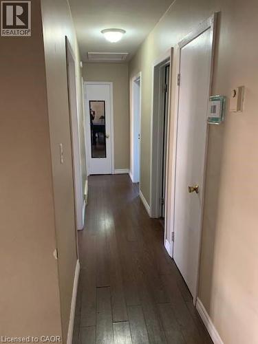 Corridor with baseboards and dark wood-style floors - 65 Cardill Crescent Unit# A, Waterloo, ON - Indoor Photo Showing Other Room