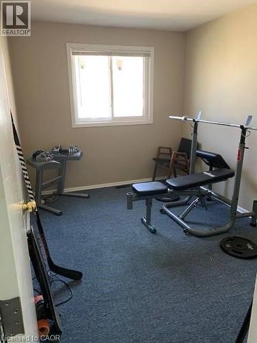 Exercise room with carpet flooring and baseboards - 65 Cardill Crescent Unit# A, Waterloo, ON - Indoor Photo Showing Gym Room