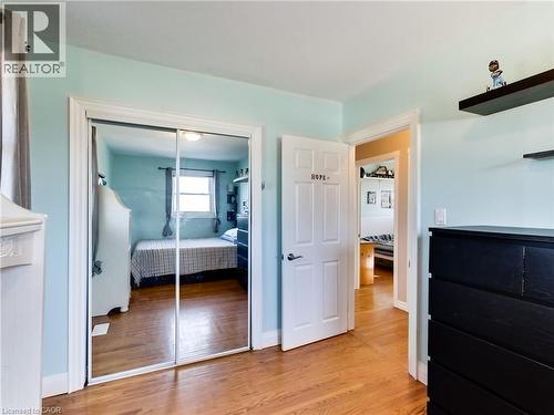 Bedroom featuring light wood-style floors and a closet - 9183 Silver Street, Caistor Centre, ON - Indoor Photo Showing Bedroom