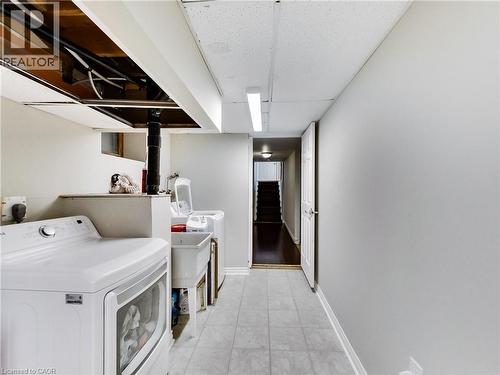 Laundry area with light tile patterned flooring and hookup for an electric dryer - 9183 Silver Street, Caistor Centre, ON - Indoor Photo Showing Laundry Room