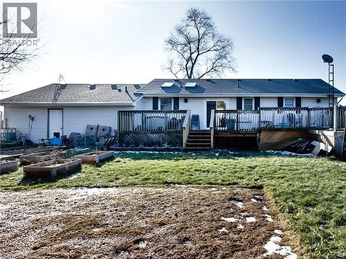 Back of property featuring a vegetable garden, a lawn, a deck, and a shingled roof - 9183 Silver Street, Caistor Centre, ON - Outdoor With Deck Patio Veranda