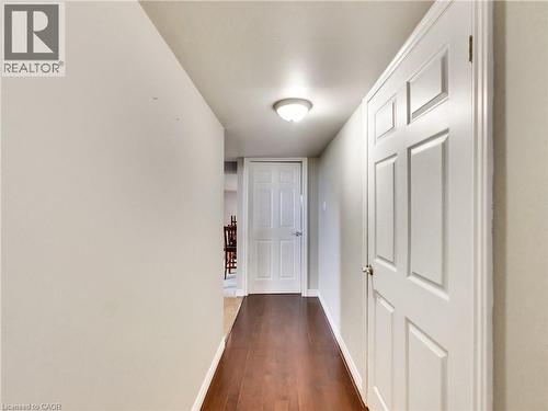 Hallway featuring wood-finish flooring and light-toned walls - 9183 Silver Street, Caistor Centre, ON - Indoor Photo Showing Other Room