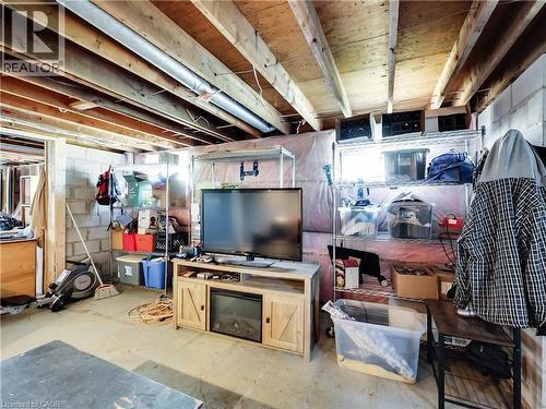Unfinished basement area featuring exposed ceiling joists, concrete block walls, and a concrete floor - 9183 Silver Street, Caistor Centre, ON - Indoor Photo Showing Basement