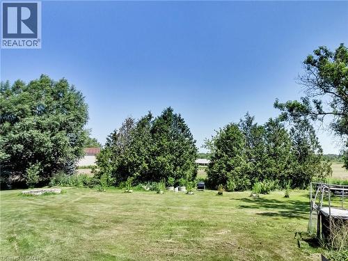 Expansive outdoor space featuring a manicured lawn, mature trees, and landscaping elements - 9183 Silver Street, Caistor Centre, ON - Outdoor