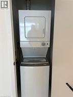 The property features a stacked white washer and dryer unit, conveniently located within a dedicated closet space - 