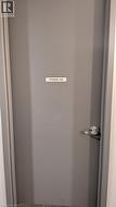 Storage unit with a gray door and brushed nickel handle - 
