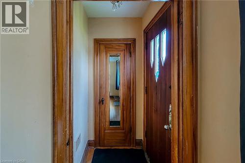 Entryway featuring a wood-panel door with decorative glass inserts, natural wood trim, and wood-finish flooring - 66 Cline Avenue Unit# Main Floor, Hamilton, ON - Indoor Photo Showing Other Room