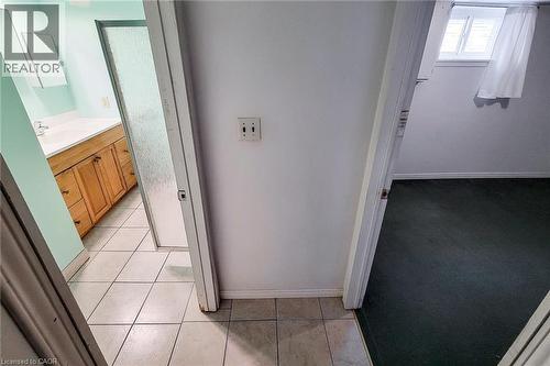 Bathroom featuring a single vanity with wood cabinetry, a white countertop, and an integrated sink - 66 Cline Avenue Unit# Main Floor, Hamilton, ON - Indoor