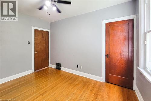 Hardwood flooring and light grey walls - 66 Cline Avenue Unit# Main Floor, Hamilton, ON - Indoor Photo Showing Other Room