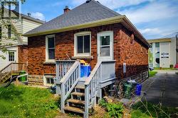 Brick exterior with a dark shingle roof and white soffit - 