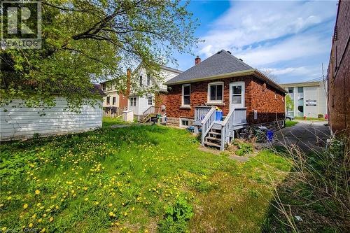 Brick exterior with a dark shingle roof and white trim - 66 Cline Avenue Unit# Main Floor, Hamilton, ON - Outdoor