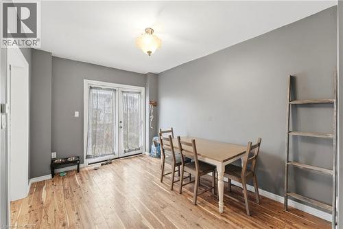 The interior features hardwood flooring, light grey walls, and a light fixture on the ceiling - 99 Robins Avenue, Hamilton, ON - Indoor Photo Showing Dining Room