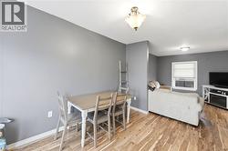 This interior space features hardwood flooring, neutral gray walls, and white ceiling trim - 