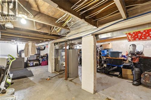 This property features an unfinished basement with concrete floors and exposed ceiling joists - 99 Robins Avenue, Hamilton, ON - Indoor Photo Showing Basement