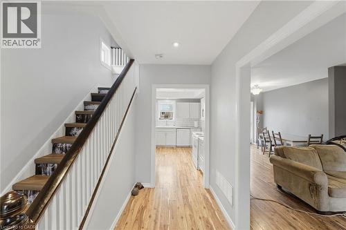 The property features hardwood flooring throughout the main level - 99 Robins Avenue, Hamilton, ON - Indoor Photo Showing Other Room