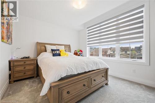 Bedroom with light grey carpeting and white baseboards - 213 Fallowfield Drive, Kitchener, ON - Indoor Photo Showing Bedroom