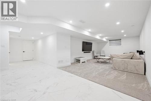 Spacious lower level featuring white walls and recessed lighting - 213 Fallowfield Drive, Kitchener, ON - Indoor