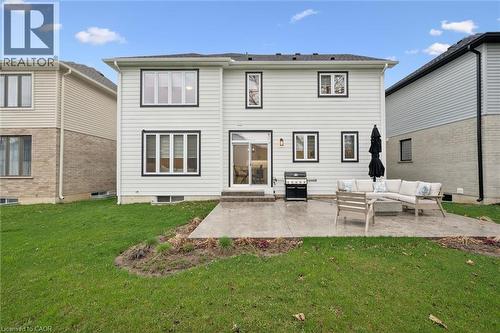 Rear exterior featuring light-colored siding with contrasting dark window trim - 213 Fallowfield Drive, Kitchener, ON - Outdoor