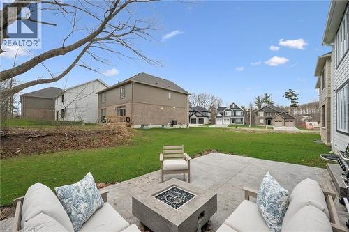 Expansive concrete patio featuring a built-in fire pit - 213 Fallowfield Drive, Kitchener, ON - Outdoor
