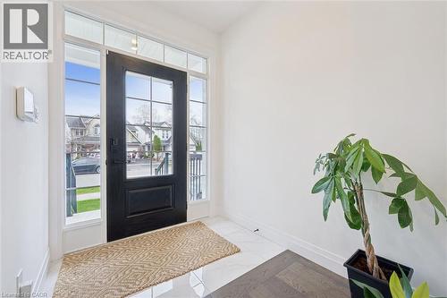 Entryway featuring a black paneled door with grid-patterned glass inserts and sidelights - 213 Fallowfield Drive, Kitchener, ON - Indoor Photo Showing Other Room