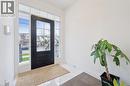 Entryway featuring a black paneled door with grid-patterned glass inserts and sidelights - 213 Fallowfield Drive, Kitchener, ON  - Indoor Photo Showing Other Room 